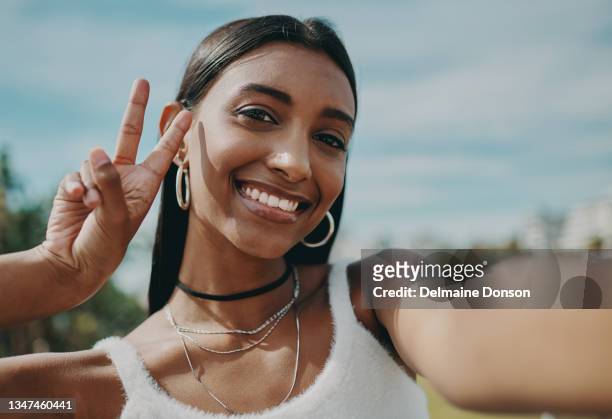 shot of a young woman taking a selfie in the city - fashion for peace stock pictures, royalty-free photos & images