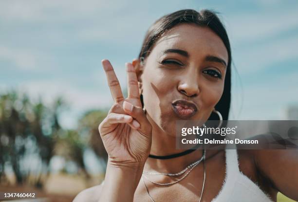 shot of a young woman taking a selfie in the city - puckering stock pictures, royalty-free photos & images