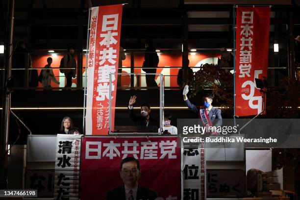 Japan Communist Party candidate Tadashi Shimizu waves to voters from a campaign truck during the official election party campaign for the upcoming...