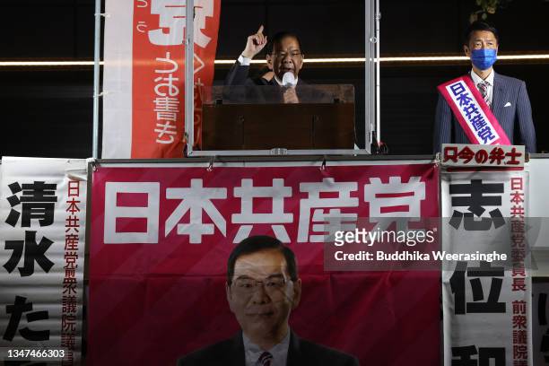 Japan Communist Party candidate Tadashi Shimizu speaks to voters from campaign car during the official election party campaign for the upcoming lower...