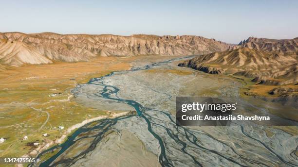 scenic aerial view of the wilderness mountain land with glacier rivers in central asia - central asia stock pictures, royalty-free photos & images