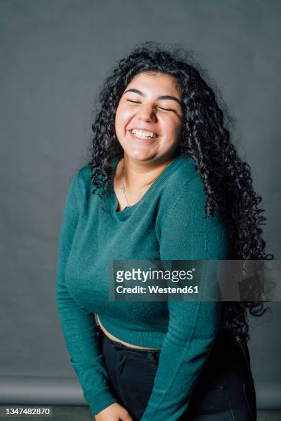 happy young oversized woman laughing in studio - chubby arab stock pictures, royalty-free photos & images