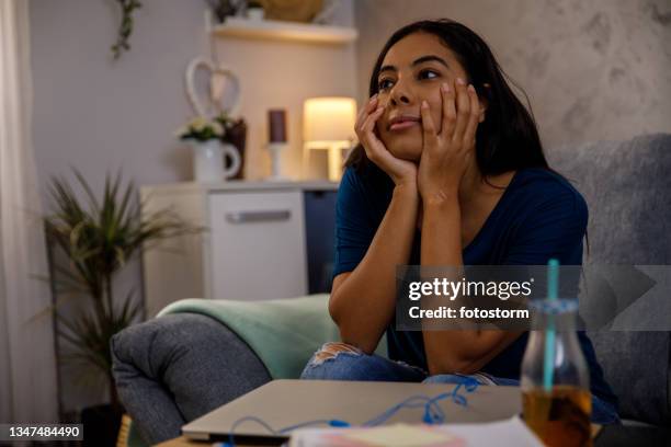 young woman watching a romantic movie on tv - north african people stock pictures, royalty-free photos & images