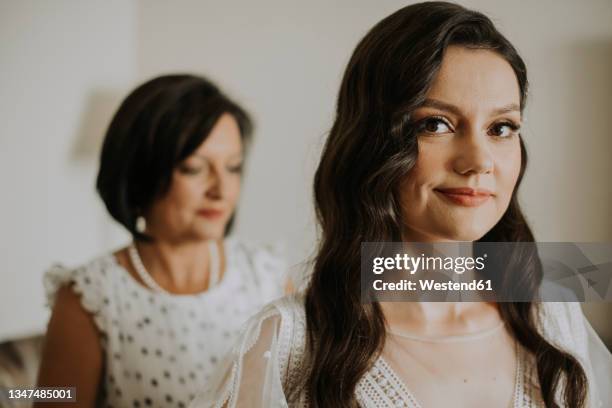 smiling bride with mother at home - bride getting dressed stock pictures, royalty-free photos & images