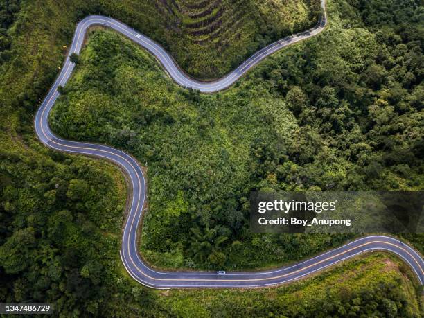 aerial view of steep curve road cutting through the mountains in northern region of thailand. - long journey stock pictures, royalty-free photos & images