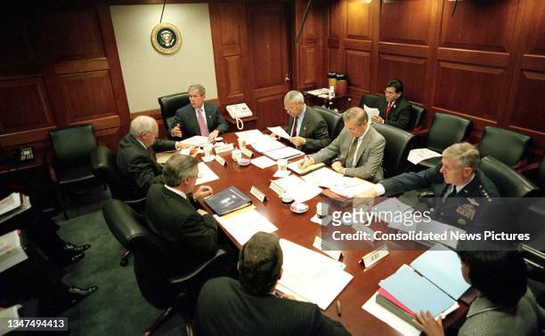 President George W Bush meets with his National Security Council in the Situation Room of the White House, Washington DC, October 12, 2001. Pictured...