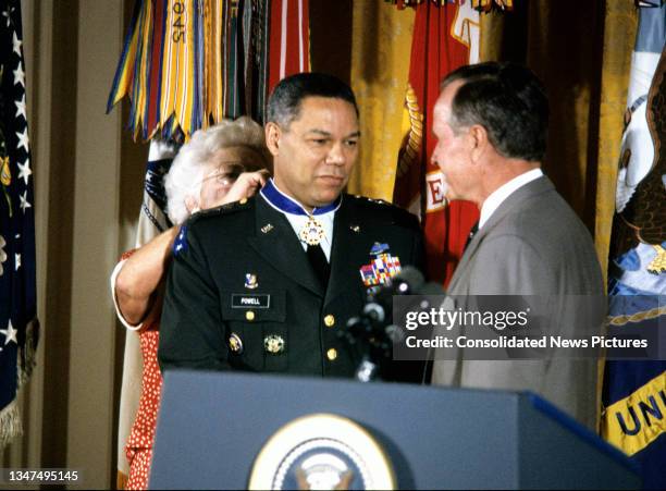 First Lady Barbara Bush presents Chairman of the Joint Chiefs of Staff Chairman General Colin L Powell with the Presidential Medal of Freedom as US...