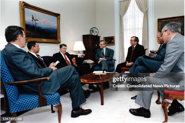 President Ronald Reagan meets with senior members of the National Security Council staff in the National Security Advisor's Office in the White...