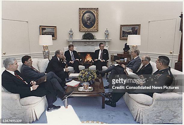 President George HW Bush meets with advisors in the White House's Oval Office, Washington DC, January 15, 1991. Pictured are, from left, United...