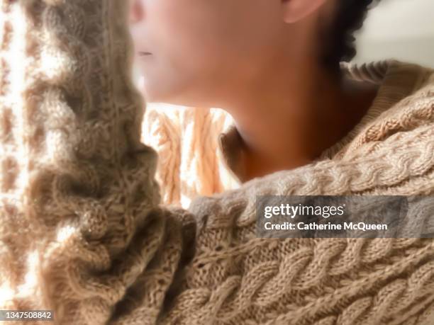 african-american woman in contemplative mood staring out window - no face stockfoto's en -beelden