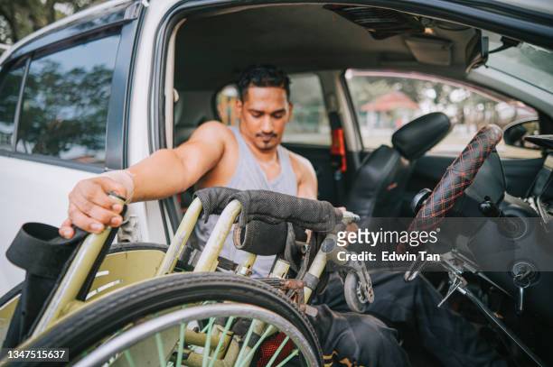 disabled asian indian man with wheelchair getting down from driver seat - förlamning bildbanksfoton och bilder