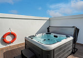 Luxury bathtub, for therapeutic massage and relaxation outside on the grass. Under the blue sky.