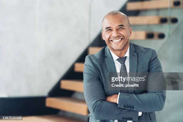 portrait of a smiling middle aged businessman - zwart pak stockfoto's en -beelden