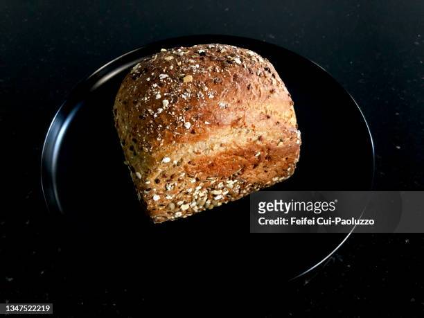 close-up of a protein bread in a black plate with black background - low carb diet stock pictures, royalty-free photos & images