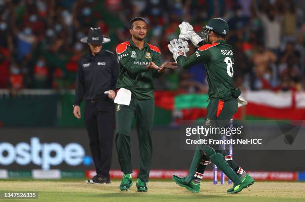 Shakib Al Hasan of Bangladesh celebrates the wicket of Jatinder Singh of Oman with team mate Nurul Hasan during the ICC Men's T20 World Cup match...