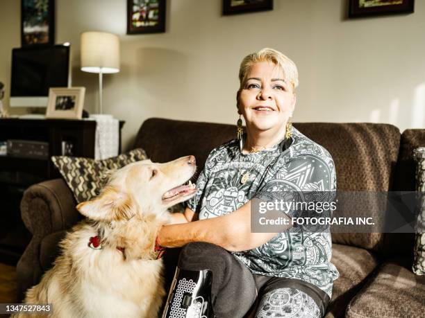 mature latin woman with disability and her dog - disability rights stock pictures, royalty-free photos & images