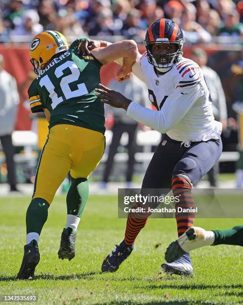 Robert Quinn of the Chicago Bears sidesteps Aaron Rodgers of the Green Bay Packers to chase a runner at Soldier Field on October 17, 2021 in Chicago,...