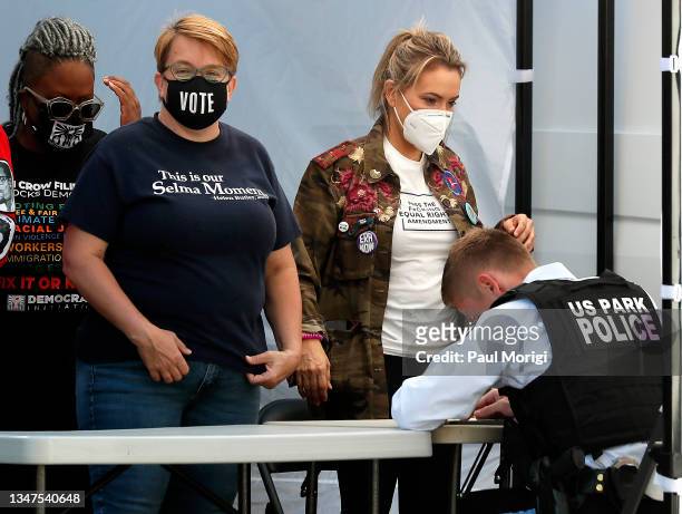 Actress and People For the American Way board member Alyssa Milano is processed for arrest after refusing to clear the area at the "No More Excuses:...