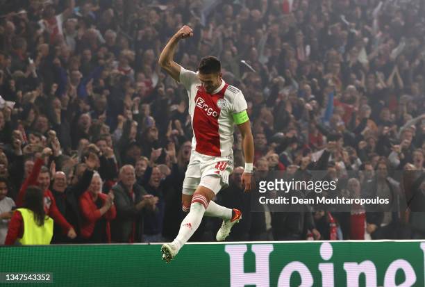 Dusan Tadic of Ajax celebrates their side's first goal, an own goal by Marco Reus of Borussia Dortmund during the UEFA Champions League group C match...