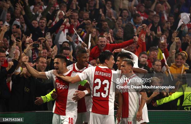 Players of Ajax celebrate their side's first goal, an own goal by Marco Reus of Borussia Dortmund during the UEFA Champions League group C match...