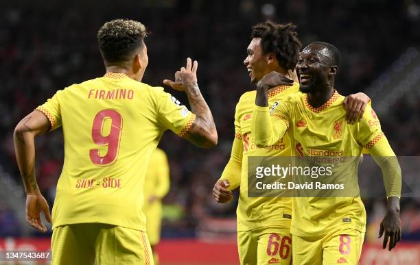 Naby Keita of Liverpool celebrates with Trent Alexander-Arnold and Roberto Firmino after scoring their side's second goal during the UEFA Champions...
