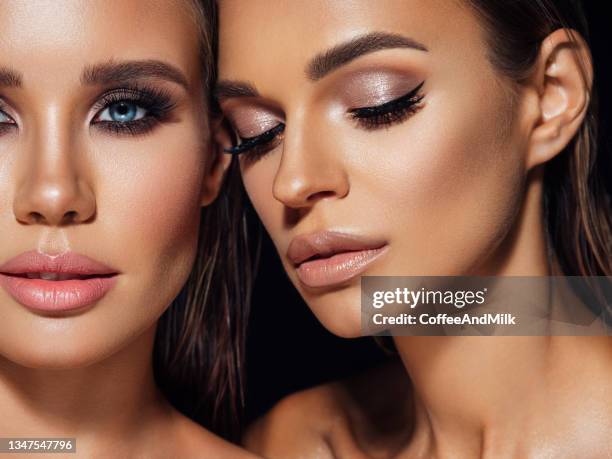 two beautiful emotional women with perfect make-up - wimper stockfoto's en -beelden