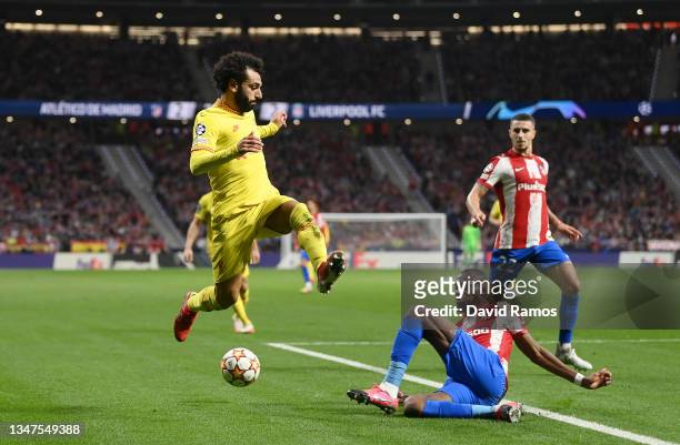Mohamed Salah of Liverpool evades a tackle from Geoffrey Kondogbia of Atletico Madrid during the UEFA Champions League group B match between Atletico...