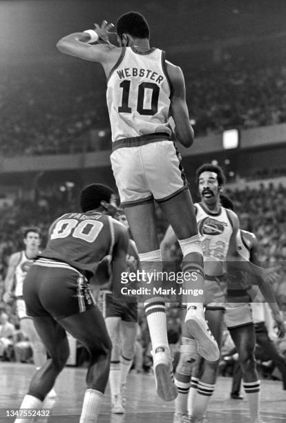 Golden State Warriors center Robert Parish fakes a leaping center Marvin Webster, who is caught in midair during an NBA basketball game against the...