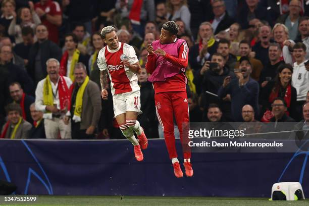 Antony of Ajax celebrates with David Neres after scoring their side's third goal during the UEFA Champions League group C match between AFC Ajax and...