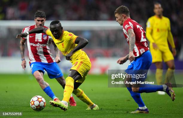 Sadio Mane of Liverpool battles for possession with Kieran Trippier of Atletico Madrid during the UEFA Champions League group B match between...