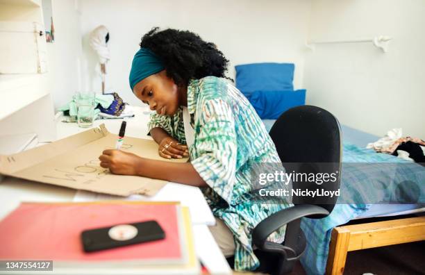 teenage girl making a protest sign at a desk in her bedroom - make room make room stock pictures, royalty-free photos & images