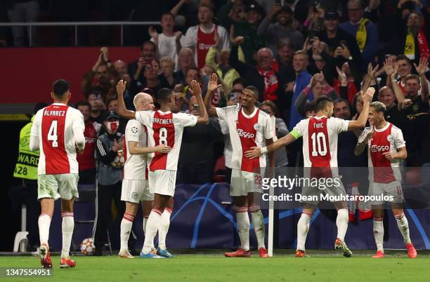 Sebastien Haller of Ajax celebrates after scoring their side's fourth goal with team mates during the UEFA Champions League group C match between AFC...