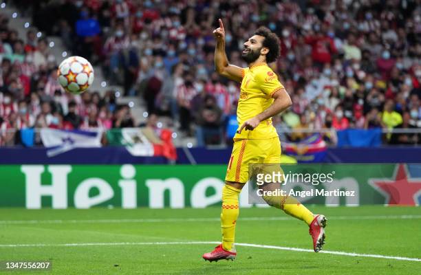 Mohamed Salah of Liverpool celebrates after scoring their side's third goal during the UEFA Champions League group B match between Atletico Madrid...