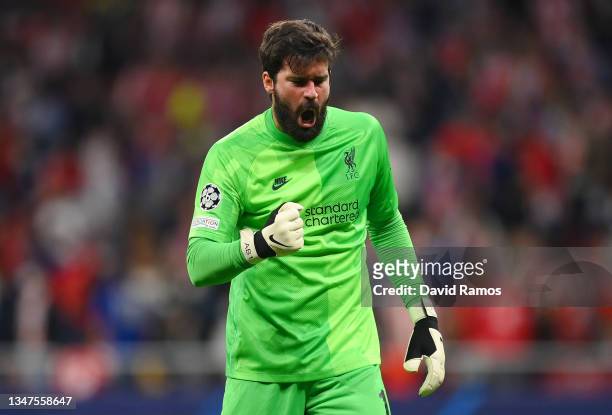 Alisson Becker of Liverpool celebrates their side's victory after the UEFA Champions League group B match between Atletico Madrid and Liverpool FC at...
