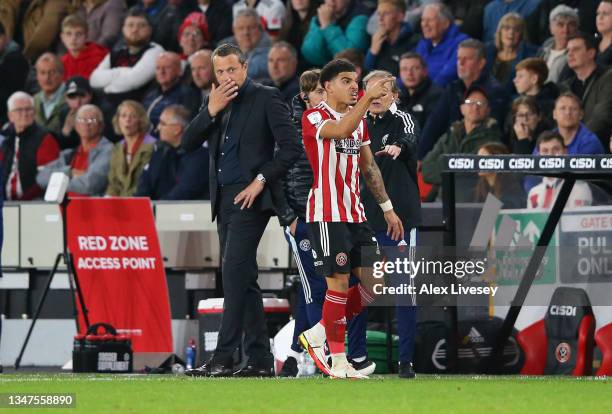 Morgan Gibbs-White of Sheffield United walks past manager Slavisa Jokanovic after being sent off during the Sky Bet Championship match between...