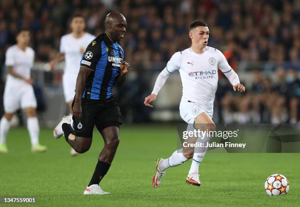 Phil Foden of Manchester City is challenged by Eder Alvarez Balanta of Club Brugge during the UEFA Champions League group A match between Club Brugge...