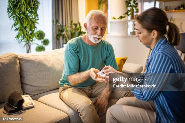 helping her old father - dementia care stock pictures, royalty-free photos & images