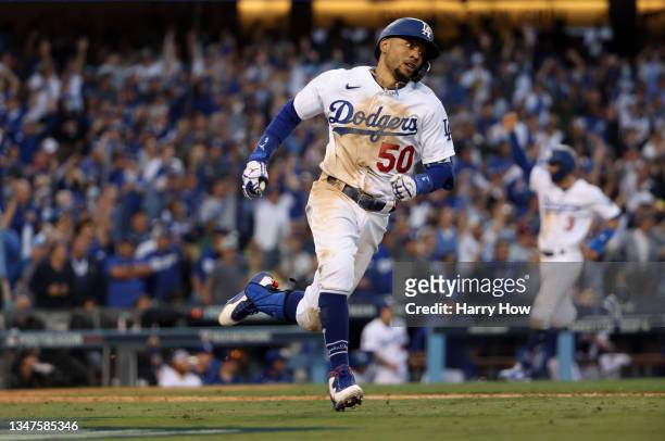 Mookie Betts of the Los Angeles Dodgers hits an RBI double during the 8th inning of Game 3 of the National League Championship Series against the...