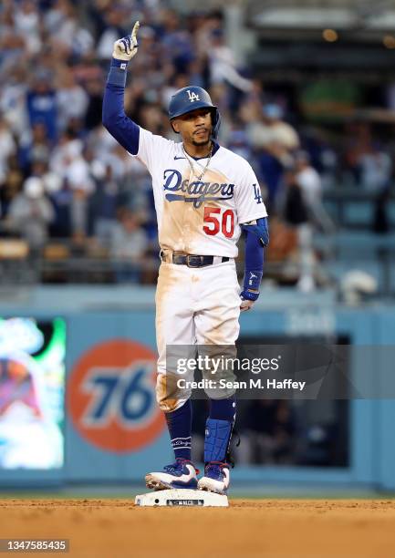 Mookie Betts of the Los Angeles Dodgers reacts after hitting an RBI double during the 8th inning of Game 3 of the National League Championship Series...