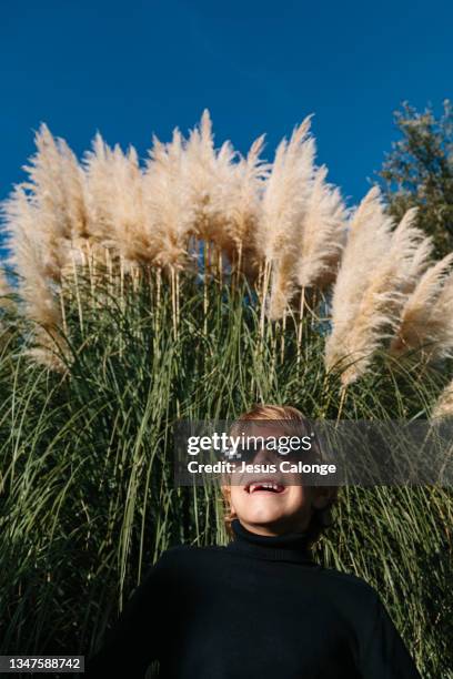 child, wearing thug life glasses, in a park. children, psychology, mischievous, hooligan and education concept. copyspace - hooligan stock-fotos und bilder