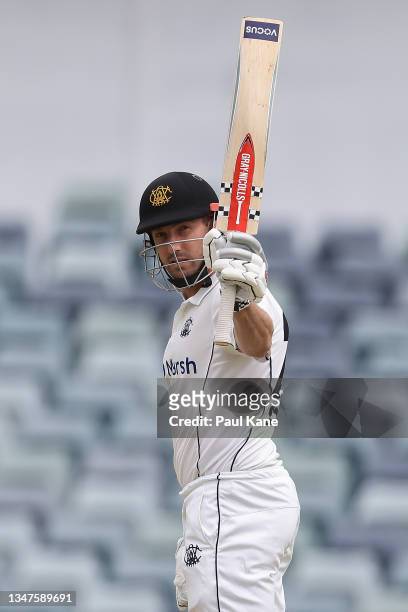 Shaun Marsh of Western Australia raises his bat after reaching his half century during day four of the Sheffield Shield match between Western...