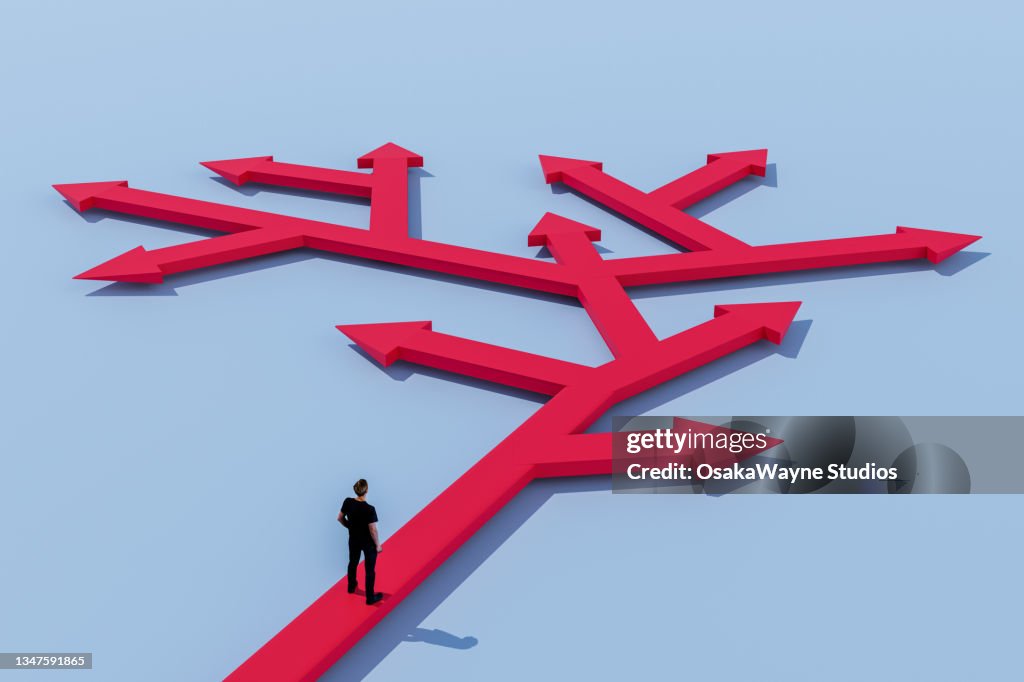 Man standing on many-branched arrow, choice and decision