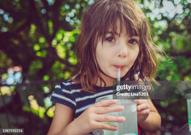 cute expressive kid drinking water from a to go cup with a straw - drinking refreshing stock pictures, royalty-free photos & images