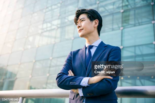 businessman looking away portrait - office building exterior dusk stock pictures, royalty-free photos & images