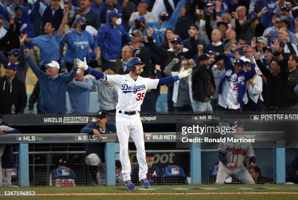 Cody Bellinger of the Los Angeles Dodgers reacts as he rounds the bases after hitting a 3-run home run during the 8th inning of Game 3 of the...