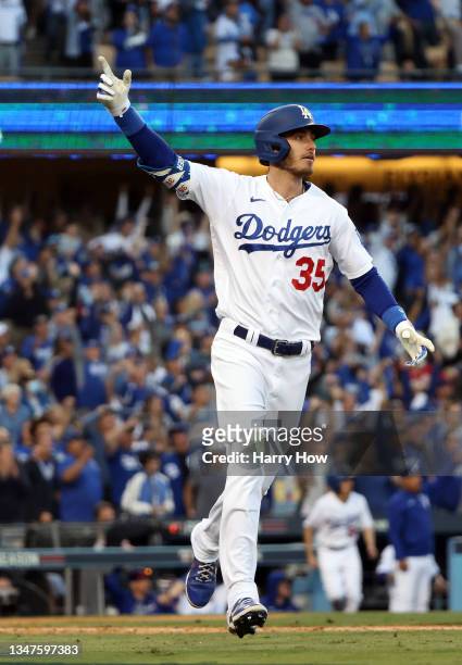 Cody Bellinger of the Los Angeles Dodgers reacts as he hits a 3-run home run during the 8th inning of Game 3 of the National League Championship...