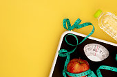 Weight scale and measure tape with a fresh apple , Healthy diet for weight loss control concept