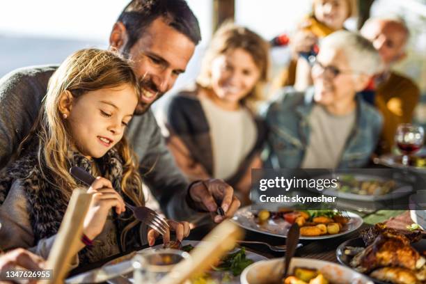 happy girl enjoying in lunch with her family on a terrace. - restaurant kids stockfoto's en -beelden