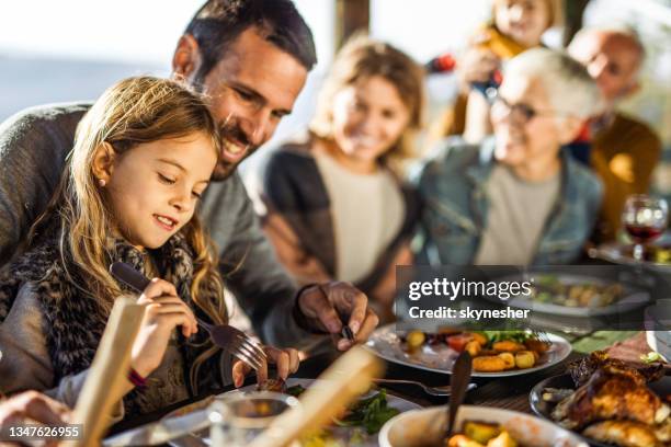 happy girl enjoying in lunch with her family on a terrace. - restaurant outside stock pictures, royalty-free photos & images
