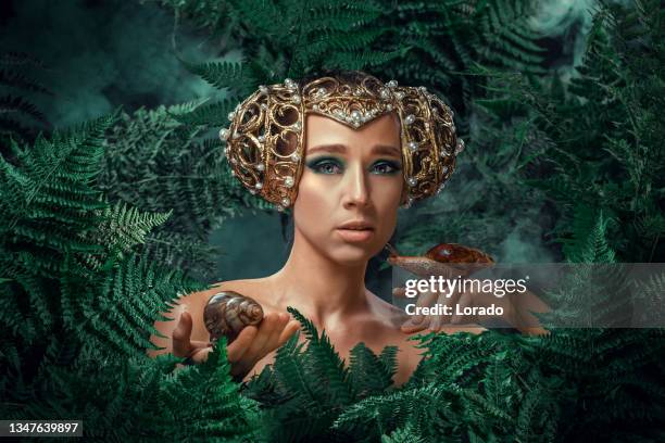 mother nature figure with snails - animal welfare stock pictures, royalty-free photos & images